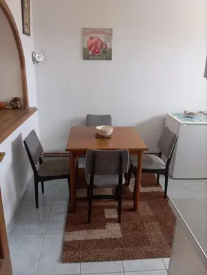 a kitchen with a wooden table and chairs in a kitchen at MAM apartmani in Bosanski Brod