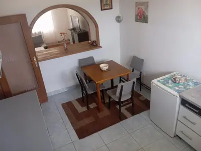 a kitchen with a table and a small table and chairs at MAM apartmani in Bosanski Brod