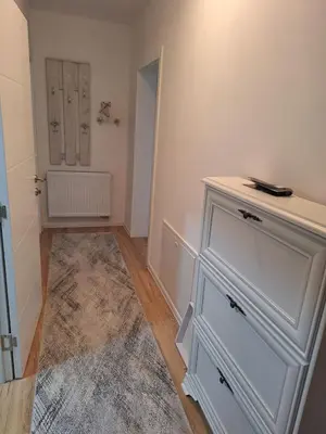 a room with a white dresser and a door at Bugojno centar in Bugojno