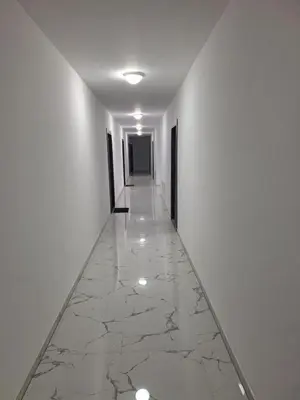 an empty hallway with white walls and marble floors at Bugojno centar in Bugojno