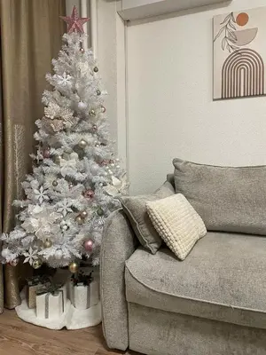 a white christmas tree in a living room next to a couch at ALTI Modern & Comfort Apartment - Free Garage Parking in Tuzla