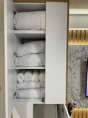 a closet filled with white towels at ALTI Modern & Comfort Apartment - Free Garage Parking in Tuzla