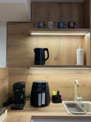 a kitchen with a coffee maker and a sink at ALTI Modern & Comfort Apartment - Free Garage Parking in Tuzla