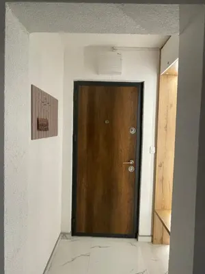 a brown door in a room with white walls at ALTI Modern & Comfort Apartment - Free Garage Parking in Tuzla