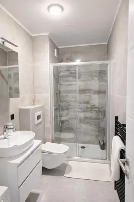 a bathroom with a shower and a toilet and a sink at Lana Apartmani Autor in Tuzla