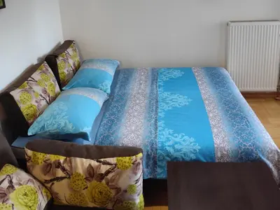 a bed with blue sheets and pillows in a room at AnyBL01 in Banja Luka