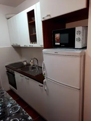 a kitchen with a microwave on top of a refrigerator at AnyBL01 in Banja Luka