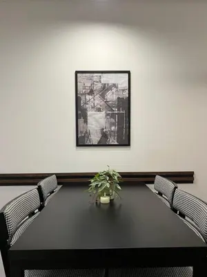 a meeting room with a table and two chairs at Lux Apartman Kotor Varoš in Donja Varoš