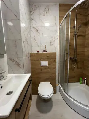 a bathroom with a toilet and a shower and a sink at Lux Apartman Kotor Varoš in Donja Varoš