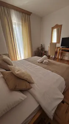 a bedroom with two beds and a window at Villa Una in Bihać