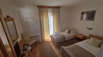 a hotel room with two beds and a window at Villa Una in Bihać