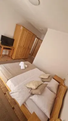 a large bed with pillows in a room at Villa Una in Bihać