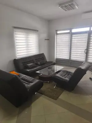 a living room with black leather furniture and a table at Vila Gunša in Šipovo