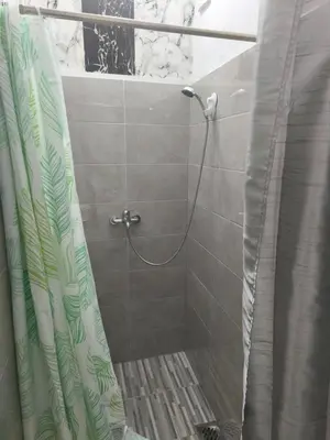 a shower with a shower curtain in a bathroom at Vila Gunša in Šipovo