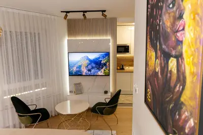 a living room with a white table and chairs at Urban Studio I