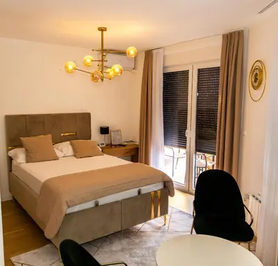 a bedroom with a bed and a table and chairs at Urban Studio I