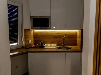 a kitchen counter with a sink and a microwave at Urban Studio I