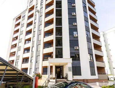 a tall white building with a staircase in front of it at Urban Studio I