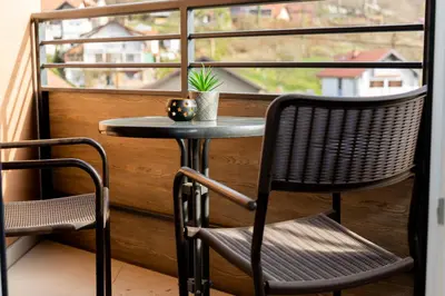 a small table and chairs on a balcony with a window at Urban Studio I