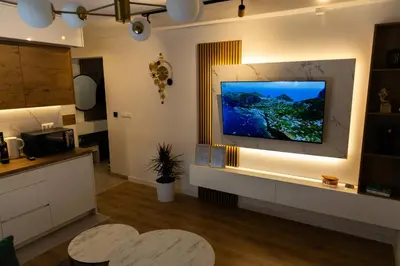 a living room with a flat screen tv on a wall at Urban Studio II