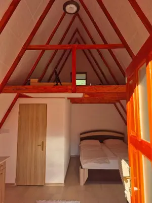 a bedroom with a bunk bed in a roof at Adna 's Home in Orašac