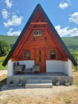 a log cabin with two chairs and a porch at Adna 's Home in Orašac