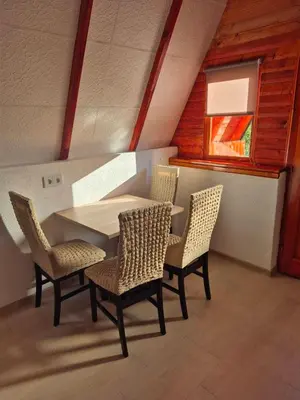 a table and chairs in a room with a window at Adna 's Home in Orašac