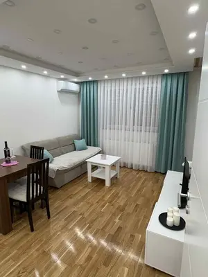 a living room with a couch and a table at Apartman Andjela Doboj in Doboj