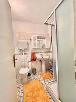 a small bathroom with a toilet and a sink at Apartman Hela in Ivišovo Greblje