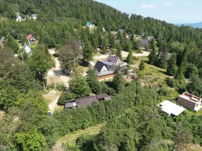 an aerial view of a house in a forest at Vikendica Brusnica