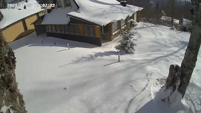 a house with snow on the ground in front at Vikendica Brusnica