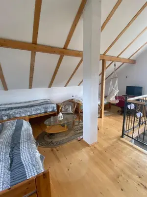 a attic room with two beds and a hammock at Planinska Vikendica Kupres Novo Selo