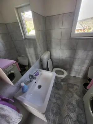 a small bathroom with a sink and a toilet at Planinska Vikendica Kupres Novo Selo