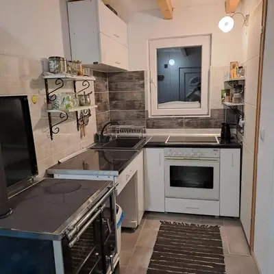 a kitchen with a sink and a stove top oven at Planinska Vikendica Kupres Novo Selo