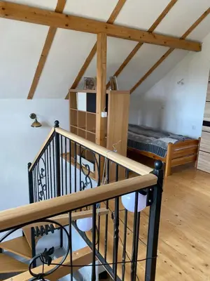 a room with a staircase and a room with a bed at Planinska Vikendica Kupres Novo Selo
