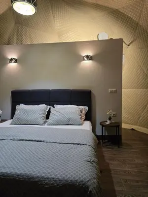 a bedroom with a large bed with two pillows at Kamp Glamp Plivska Oaza in Jajce