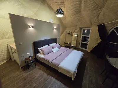 a bedroom with a large bed in a tent at Kamp Glamp Plivska Oaza in Jajce