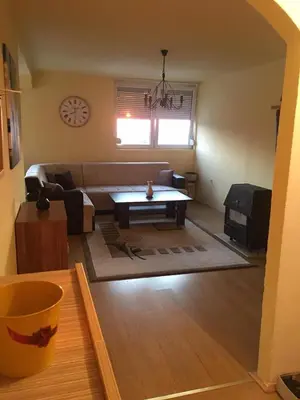 a living room with a couch and a table at ZiiNa Skyline Apartment in Bihać