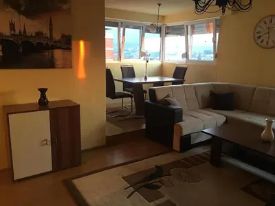 a living room with a couch and a table at ZiiNa Skyline Apartment in Bihać