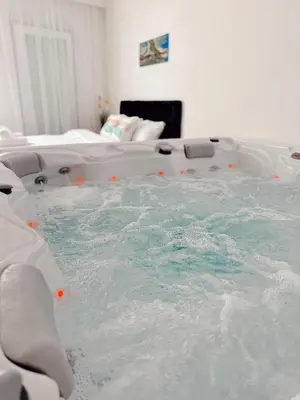 a bath tub filled with water in a room at RajRaj apartmani Gradiska in Bosanska Gradiška