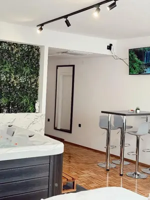 a white room with a table and a mirror at RajRaj apartmani Gradiska in Bosanska Gradiška