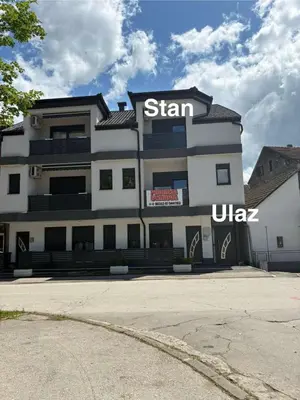 a building with a sign on the side of it at Apartment M&S in Bosanski Novi