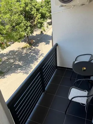 a balcony with a table and chairs on a building at Apartment M&S in Bosanski Novi