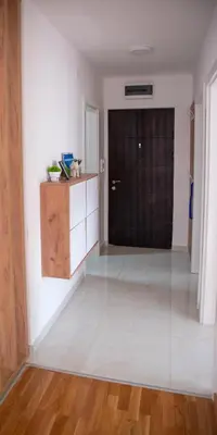 an empty room with a door and a white floor at Apartman Milica in Doboj