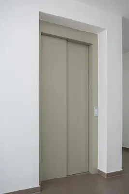 a sliding door in a room with white walls at Apartman Milica in Doboj