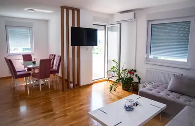 a living room with a couch and a table at Apartman Milica in Doboj