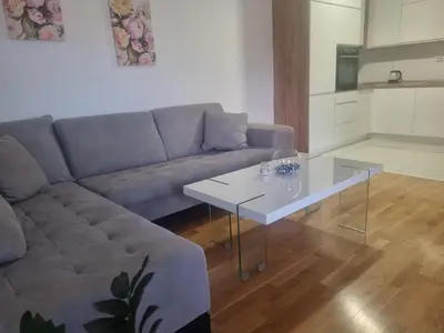 a living room with a couch and a table at Apartman Milica in Doboj