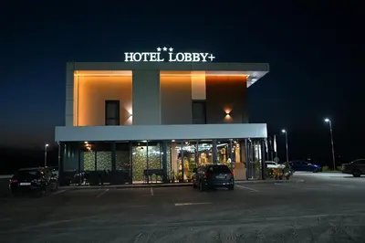 a hotel lobby with cars parked in a parking lot at Hotel LOBBY PLUS in Bihać