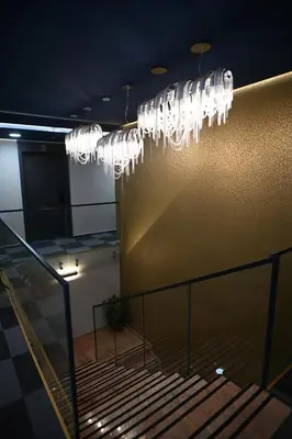 a group of wine glasses hanging from a wall at Hotel LOBBY PLUS in Bihać