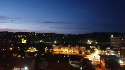 a view of a city at night with lights at City Vibe Apartment in Tuzla